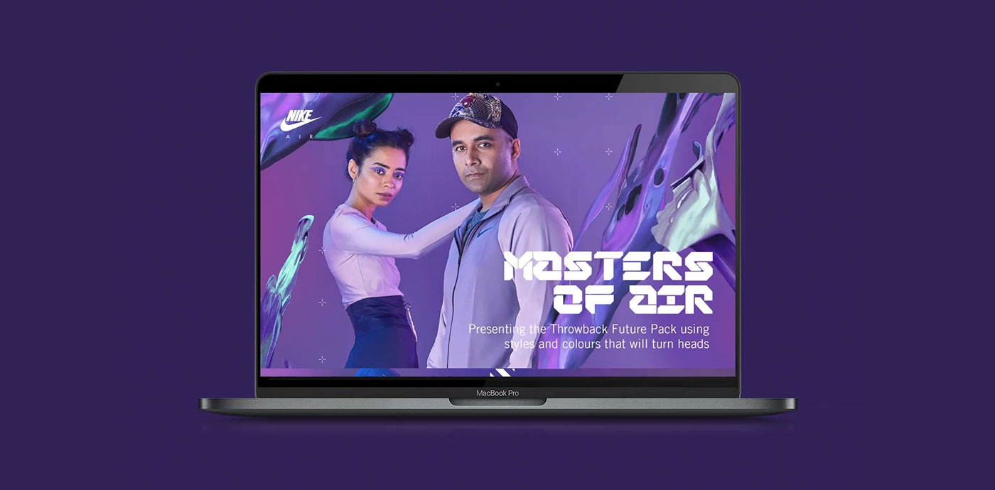 A laptop screen displaying a man and woman posing in stylish clothing, with the text 